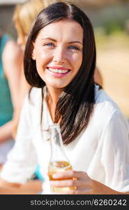 summer holidays and vacation - girl with drink and friends on the beach. girl with drink and friends on the beach