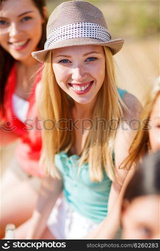 summer holidays and vacation - girl with drink and friends on the beach. girl with drink and friends on the beach