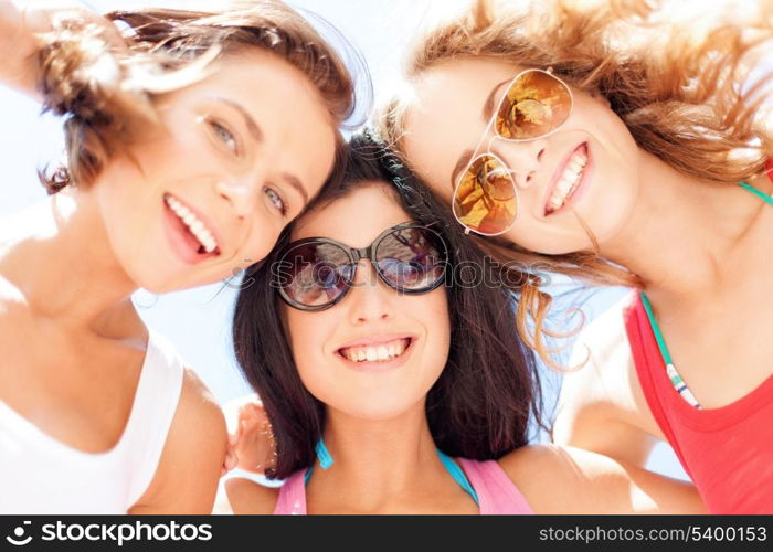 summer holidays and vacation - girls faces with shades looking down