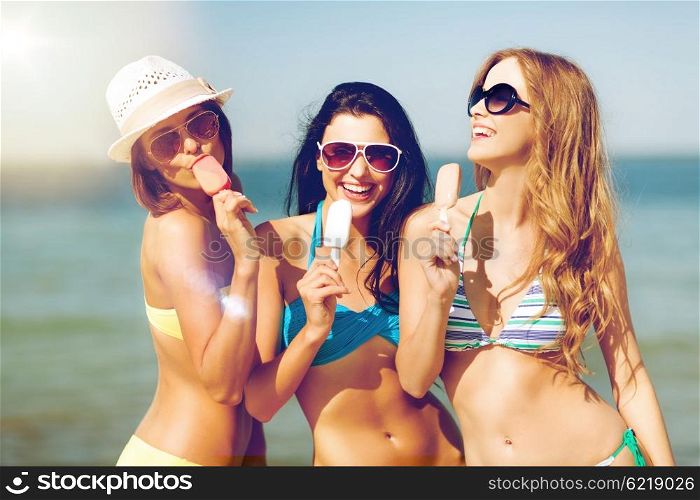 summer holidays and vacation - girls in bikini with ice cream on the beach. girls in bikini with ice cream on the beach