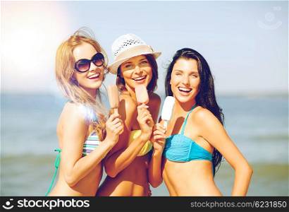 summer holidays and vacation - girls in bikini with ice cream on the beach. girls in bikini with ice cream on the beach