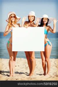 summer holidays and vacation - girls in bikinis holding blank white board on the beach. girls with blank board on the beach