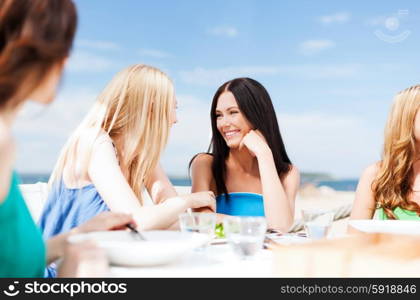 summer holidays and vacation - girls in cafe on the beach. girls in cafe on the beach