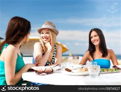 summer holidays and vacation - girls in cafe on the beach. girls in cafe on the beach