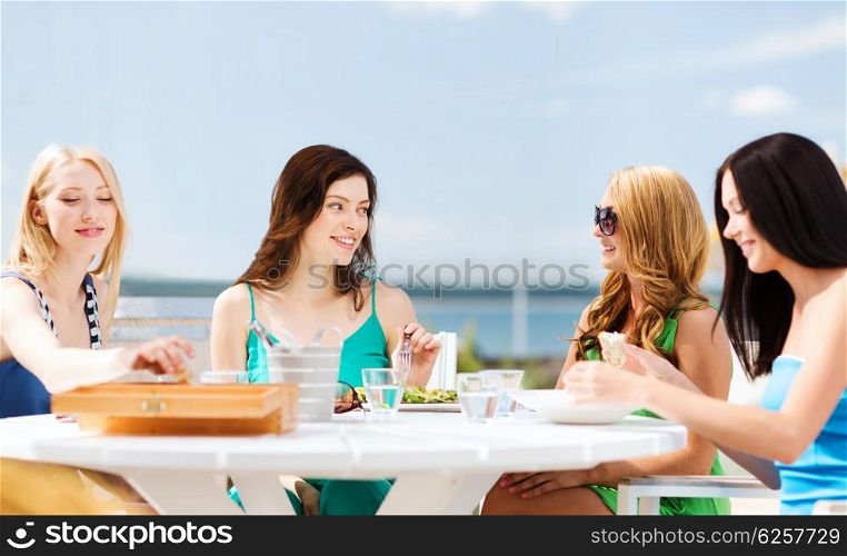 summer holidays and vacation - girls in cafe on the beach. girls in cafe on the beach