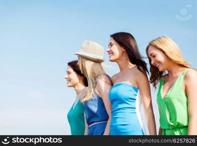 summer holidays and vacation - girls walking on the beach. girls walking on the beach