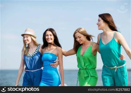 summer holidays and vacation - girls walking on the beach. girls walking on the beach