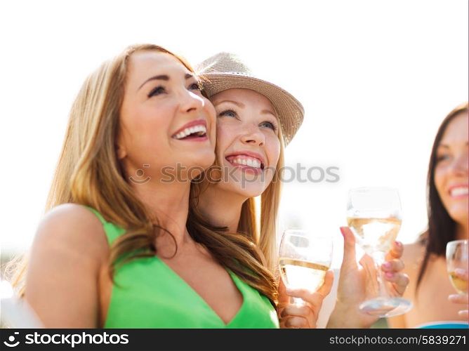summer holidays and vacation - girls with champagne glasses on boat or yacht. girls with champagne glasses on boat