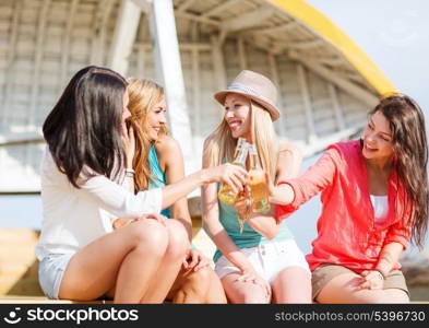 summer holidays and vacation - girls with drinks on the beach