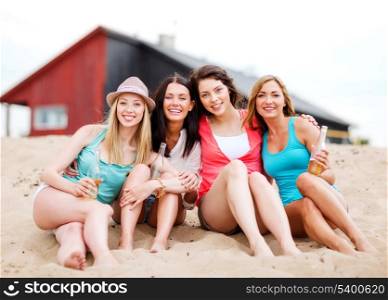 summer holidays and vacation - girls with drinks on the beach
