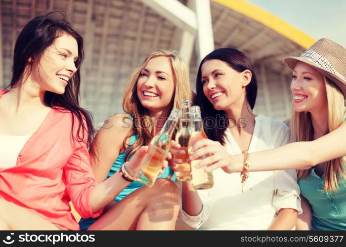 summer holidays and vacation - girls with drinks on the beach