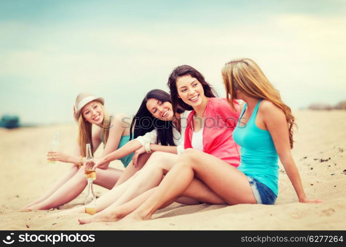 summer holidays and vacation - girls with drinks on the beach