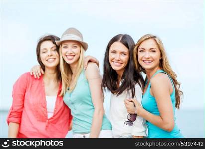summer holidays and vacation - group of girls chilling on the beach