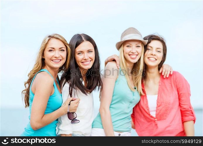 summer holidays and vacation - group of girls chilling on the beach. group of girls chilling on the beach
