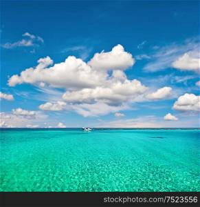 Summer holidays background. Turquoise sea water and cloudy blue sky. Paradise island