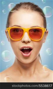 summer holidays, beauty, happiness and people concept - teenage girl in shades with expression of surprise