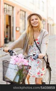 summer holidays, bikes, travel concept - attractive woman in hat with bicycle in the city