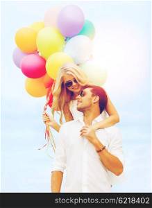 summer holidays, celebration and dating concept - couple in sunglases with colorful balloons over blue sky background