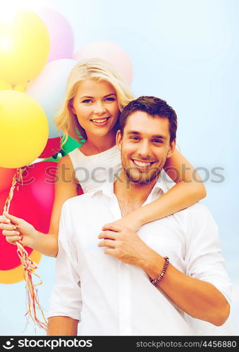 summer holidays, celebration and dating concept - couple with colorful balloons at seaside