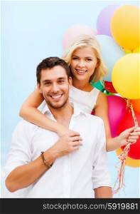 summer holidays, celebration and dating concept - couple with colorful balloons at seaside