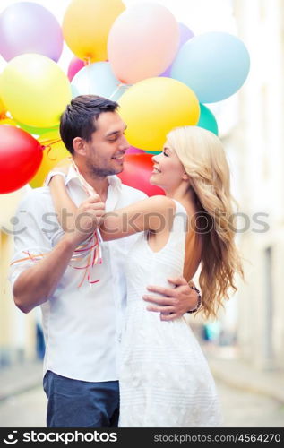 summer holidays, celebration and dating concept - couple with colorful balloons in the city