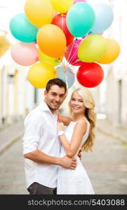 summer holidays, celebration and dating concept - couple with colorful balloons in the city