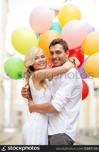 summer holidays, celebration and dating concept - couple with colorful balloons in the city