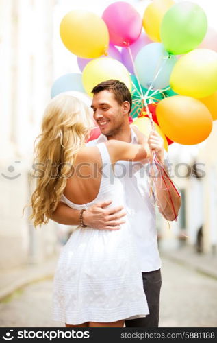 summer holidays, celebration and dating concept - couple with colorful balloons in the city