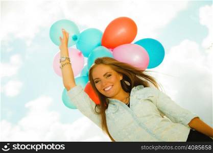 Summer holidays, celebration and lifestyle concept - beautiful woman teen girl with colorful balloons outside blue sky background