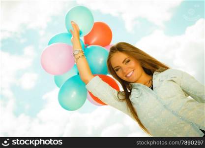 Summer holidays, celebration and lifestyle concept - beautiful woman teen girl with colorful balloons outside blue sky background