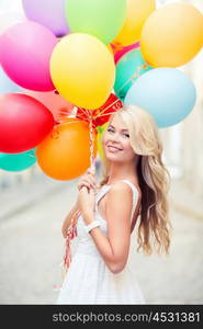 summer holidays, celebration and lifestyle concept - beautiful woman with colorful balloons in the city