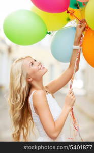 summer holidays, celebration and lifestyle concept - beautiful woman with colorful balloons in the city