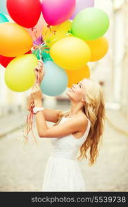 summer holidays, celebration and lifestyle concept - beautiful woman with colorful balloons in the city