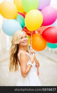 summer holidays, celebration and lifestyle concept - beautiful woman with colorful balloons in the city