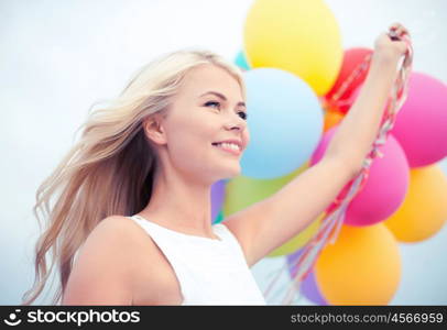 summer holidays, celebration and lifestyle concept - beautiful woman with colorful balloons outside