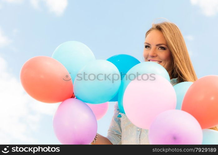 Summer holidays, celebration and lifestyle concept - Closeup beautiful woman teen girl with colorful balloons outside blue sky background