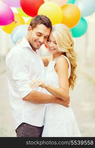 summer holidays, celebration and wedding concept - couple with colorful balloons and engagement ring