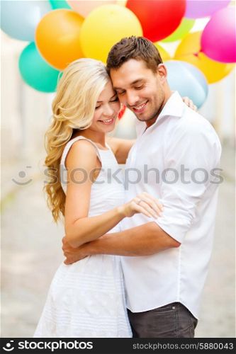 summer holidays, celebration and wedding concept - couple with colorful balloons and engagement ring