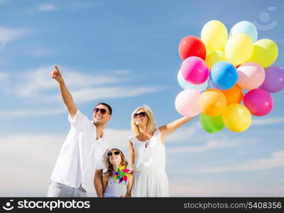 summer holidays, celebration, children and people concept - family with colorful balloons