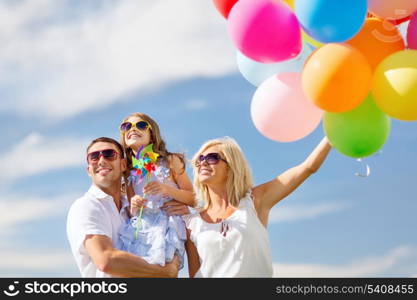 summer holidays, celebration, children and people concept - family with colorful balloons