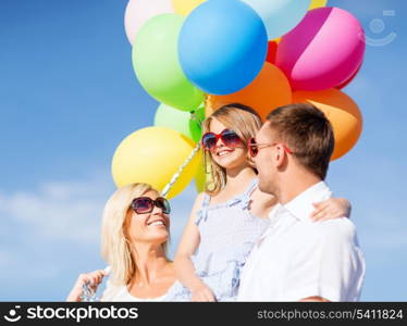 summer holidays, celebration, children and people concept - family with colorful balloons