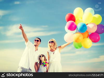 summer holidays, celebration, children and people concept - family with colorful balloons