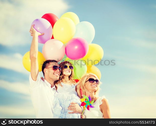 summer holidays, celebration, children and people concept - family with colorful balloons