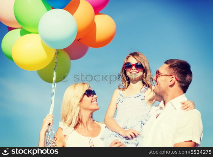 summer holidays, celebration, children and people concept - family with colorful balloons