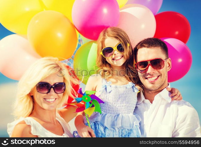 summer holidays, celebration, children and people concept - family with colorful balloons