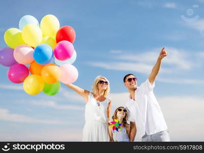 summer holidays, celebration, children and people concept - family with colorful balloons