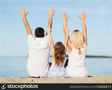 summer holidays, celebration, children and people concept - happy family at the seaside with greeting gesture