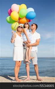 summer holidays, celebration, children and people concept - happy family with colorful balloons at seaside