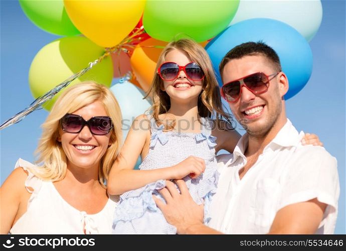summer holidays, celebration, children and people concept - happy family with colorful balloons outdoors