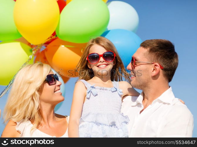 summer holidays, celebration, children and people concept - happy family with colorful balloons outdoors